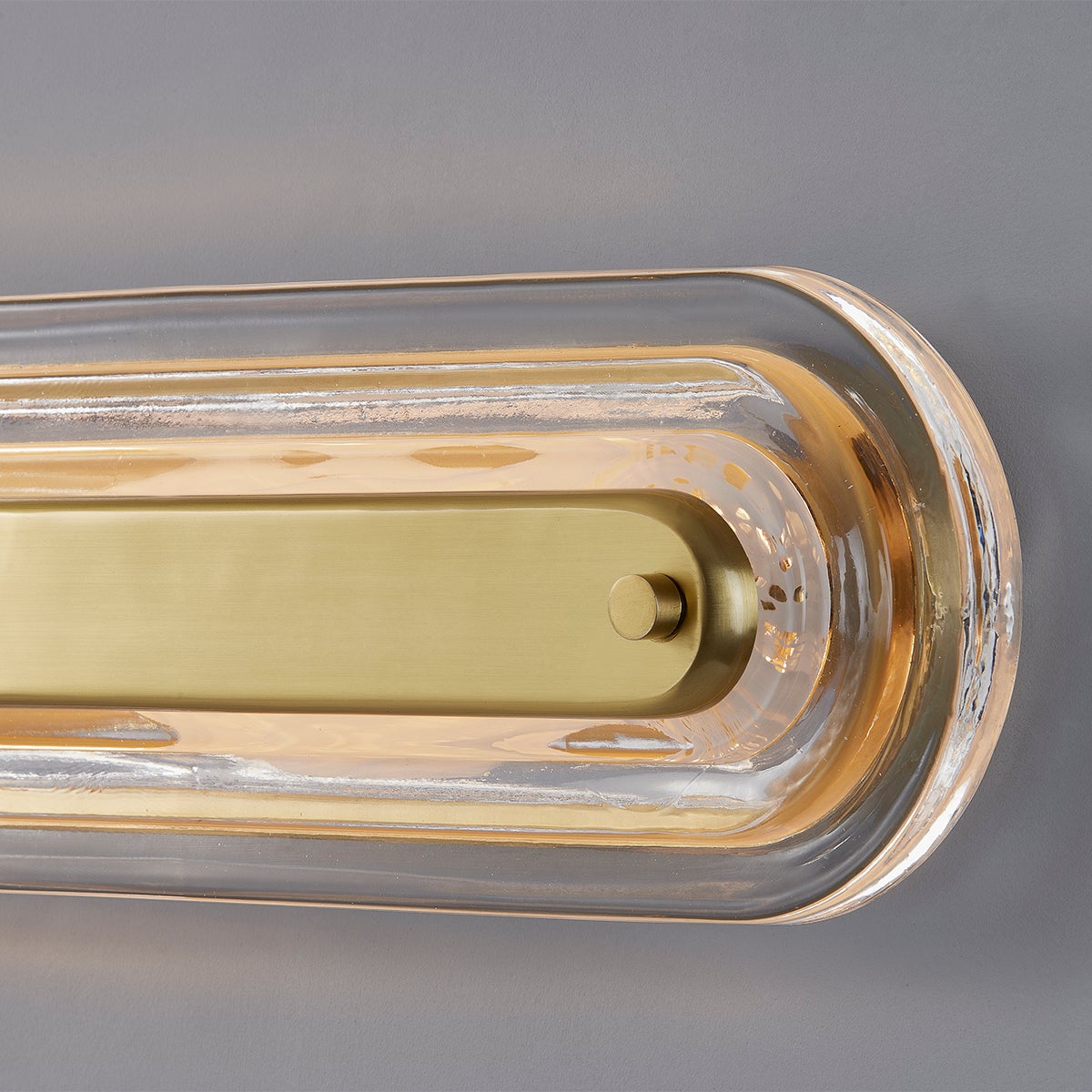 Close-up of the Litton Wall Sconce 5.75" x 21.25" in aged brass showing the arm curve and shade silhouette.