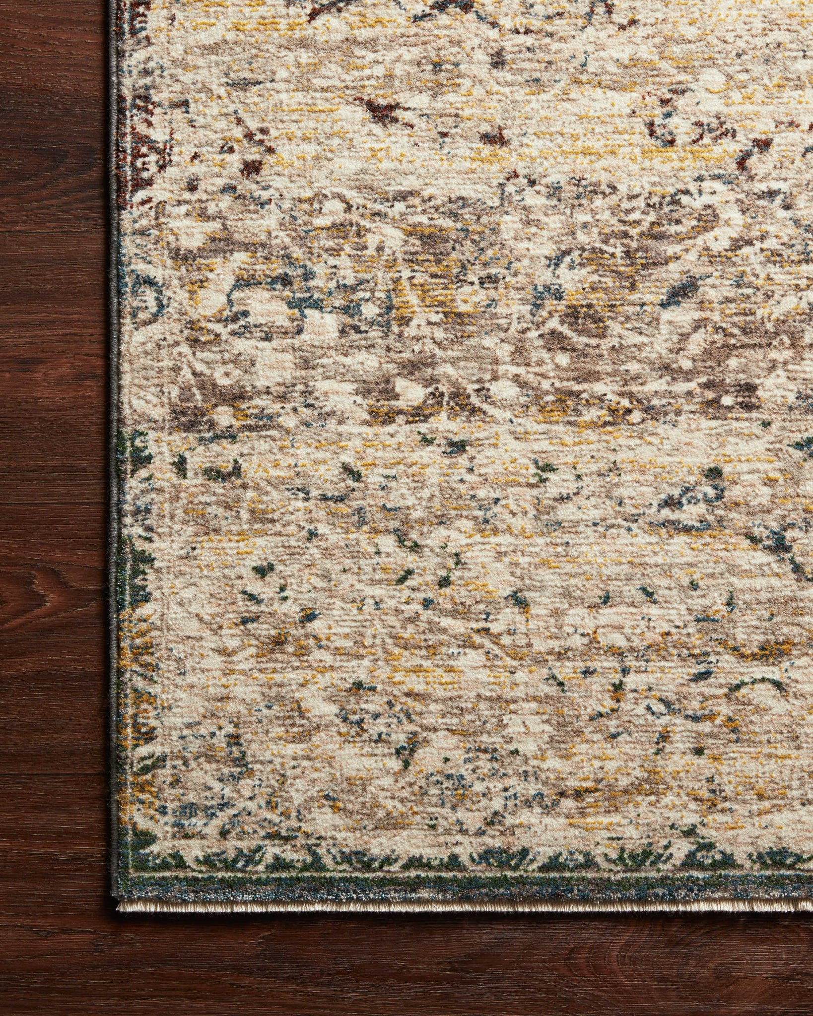 Side view of the Lourdes Ivory / Multi rug.