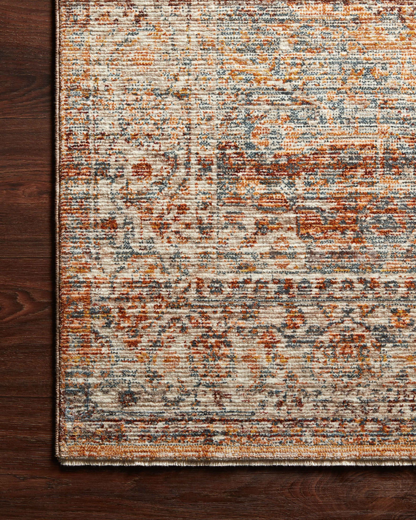 Side view of the Lourdes Tangerine / Ocean rug.