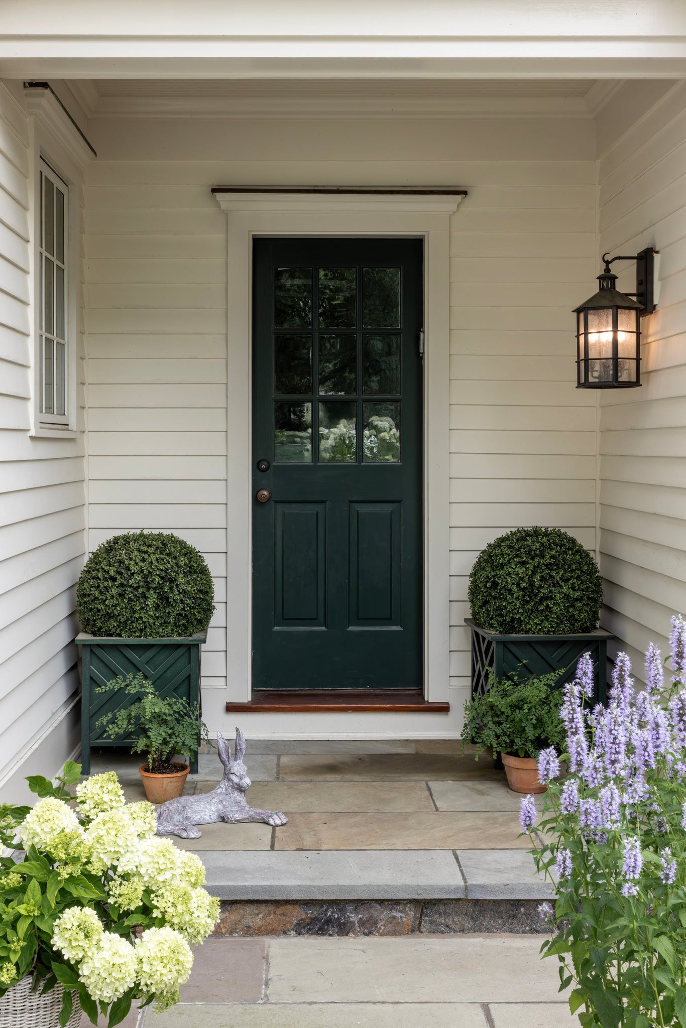 Lake County Exterior Wall Sconce 11.5" styled in a warmly lit hallway for warm, layered light at Laurie Yapp Home.