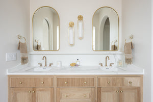 Lorimer Wall Sconce in aged brass styled in a curated living room for warm, layered light at Laurie Yapp Home.