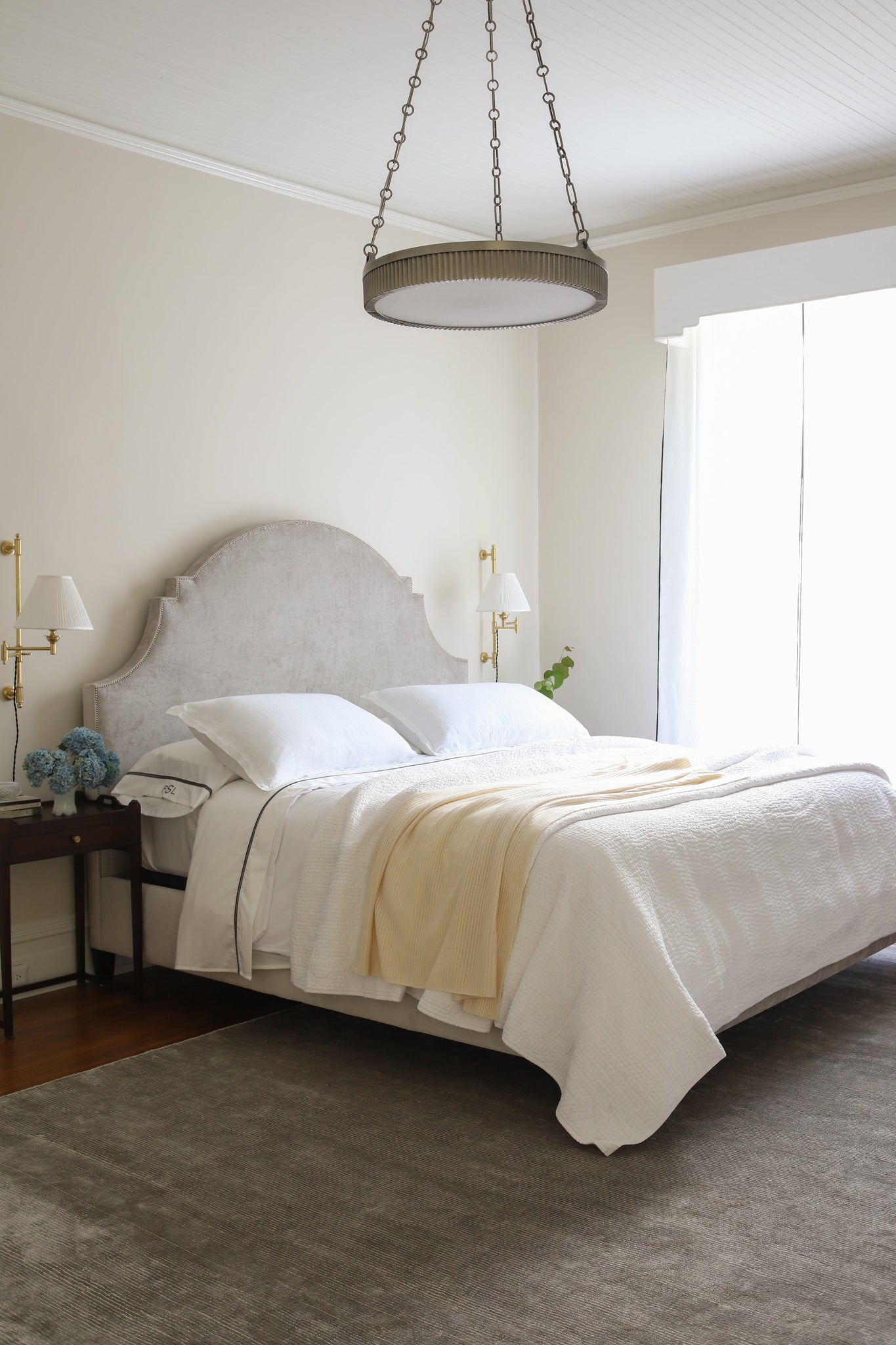 Classic No.1 Plug-In Sconce in aged brass styled in a living room for warm, layered light at Laurie Yapp Home.