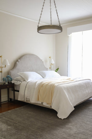 Classic No.1 Plug-In Sconce in aged brass styled in a living room for warm, layered light at Laurie Yapp Home.