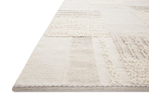 Side view of the Manfred Ivory / Pebble rug.