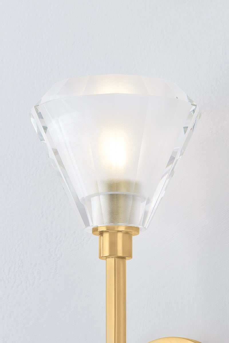 Maspeth Wall Sconce in aged brass shown from the front to reveal the arm curve and shade silhouette.