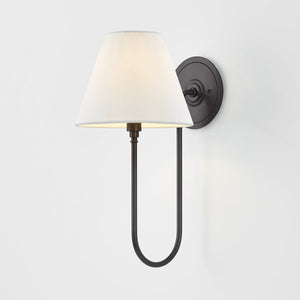 Close-up of the Hawthorne Wall Sconce in dark bronze showing the arm curve and shade silhouette.