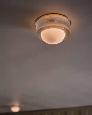 Mackay Wall Sconce 7.75" x 0" in aged brass styled in a warmly lit hallway for warm, layered light at Laurie Yapp Home.