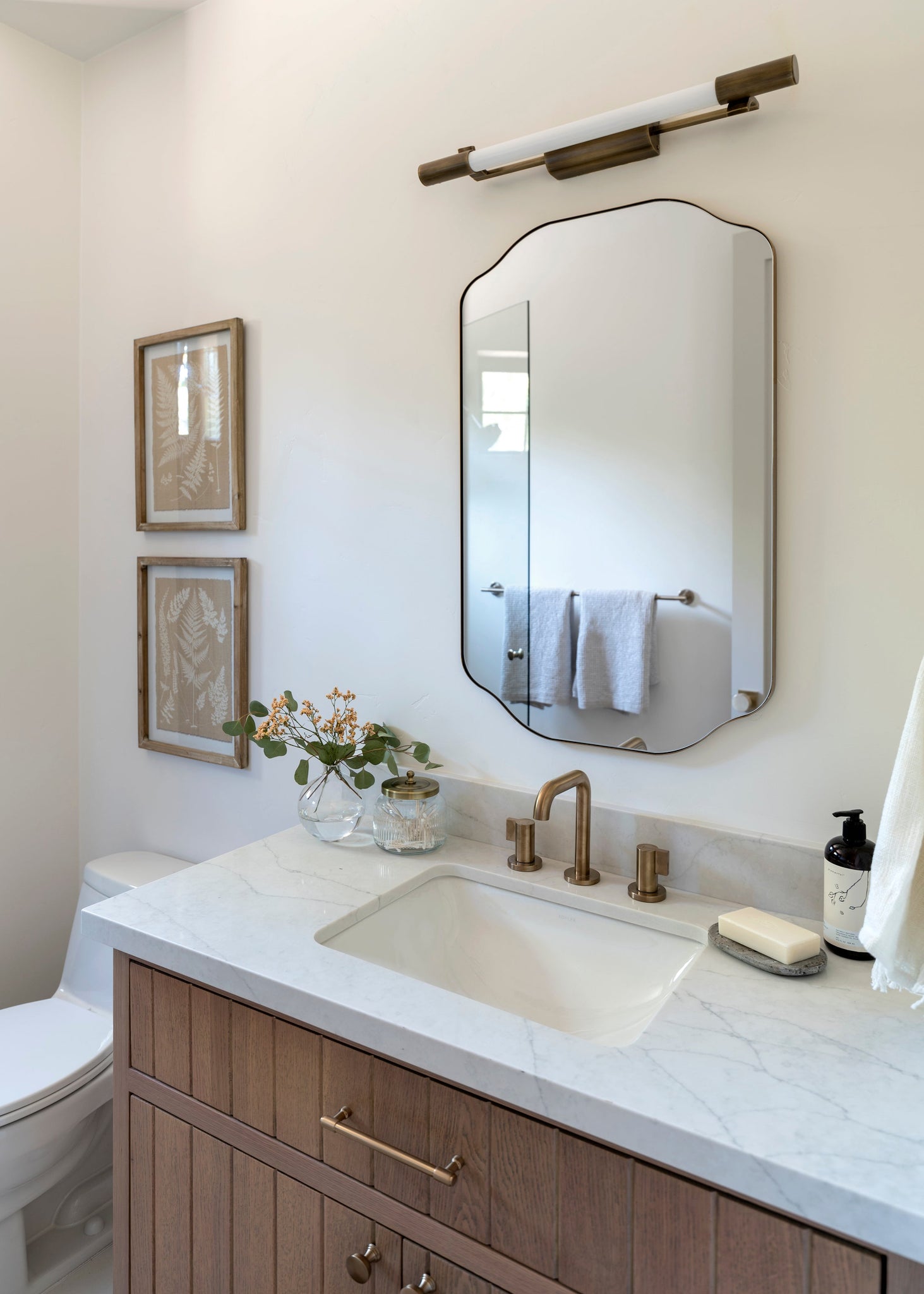 Merced Wall Sconce styled in a curated living room for warm, layered light at Laurie Yapp Home.