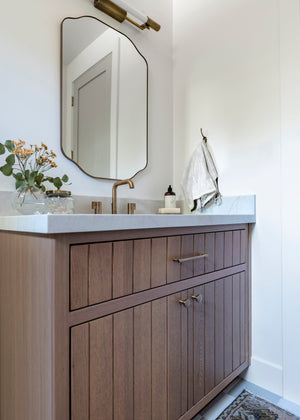 Merced Wall Sconce styled in a warmly lit hallway for warm, layered light at Laurie Yapp Home.