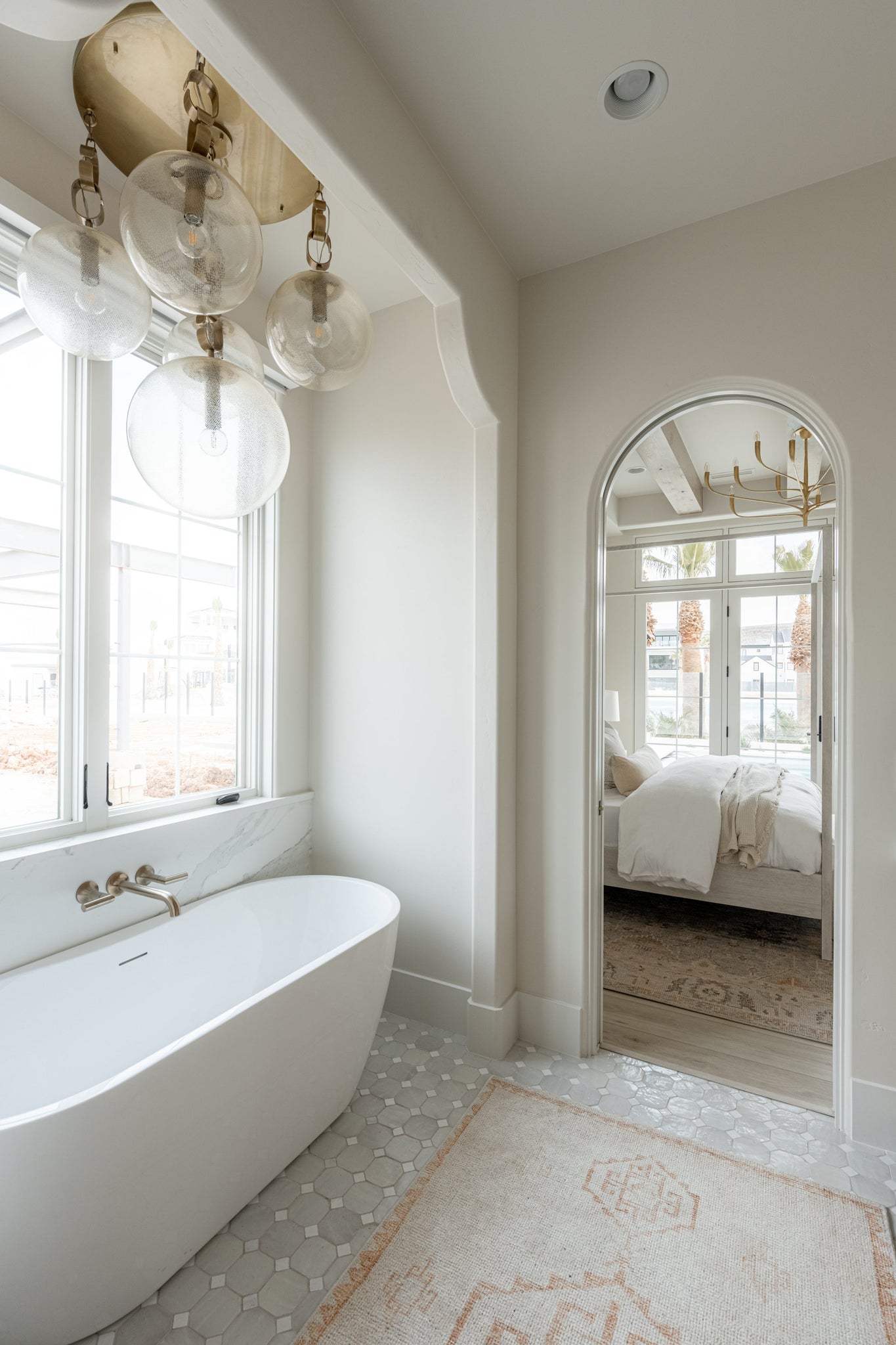 Nessa Chandelier styled in a two-story entry for warm, layered light at Laurie Yapp Home.