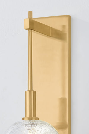 Close-up of the Onteora Wall Sconce in aged brass showing the arm curve and shade silhouette.