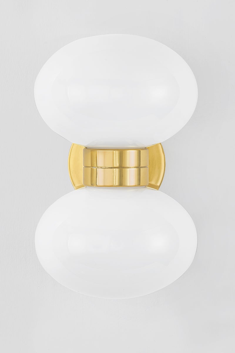 Otsego Wall Sconce in aged brass shown from the front to reveal the arm curve and shade silhouette.