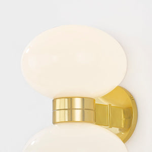 Close-up of the Otsego Wall Sconce in aged brass showing the arm curve and shade silhouette.