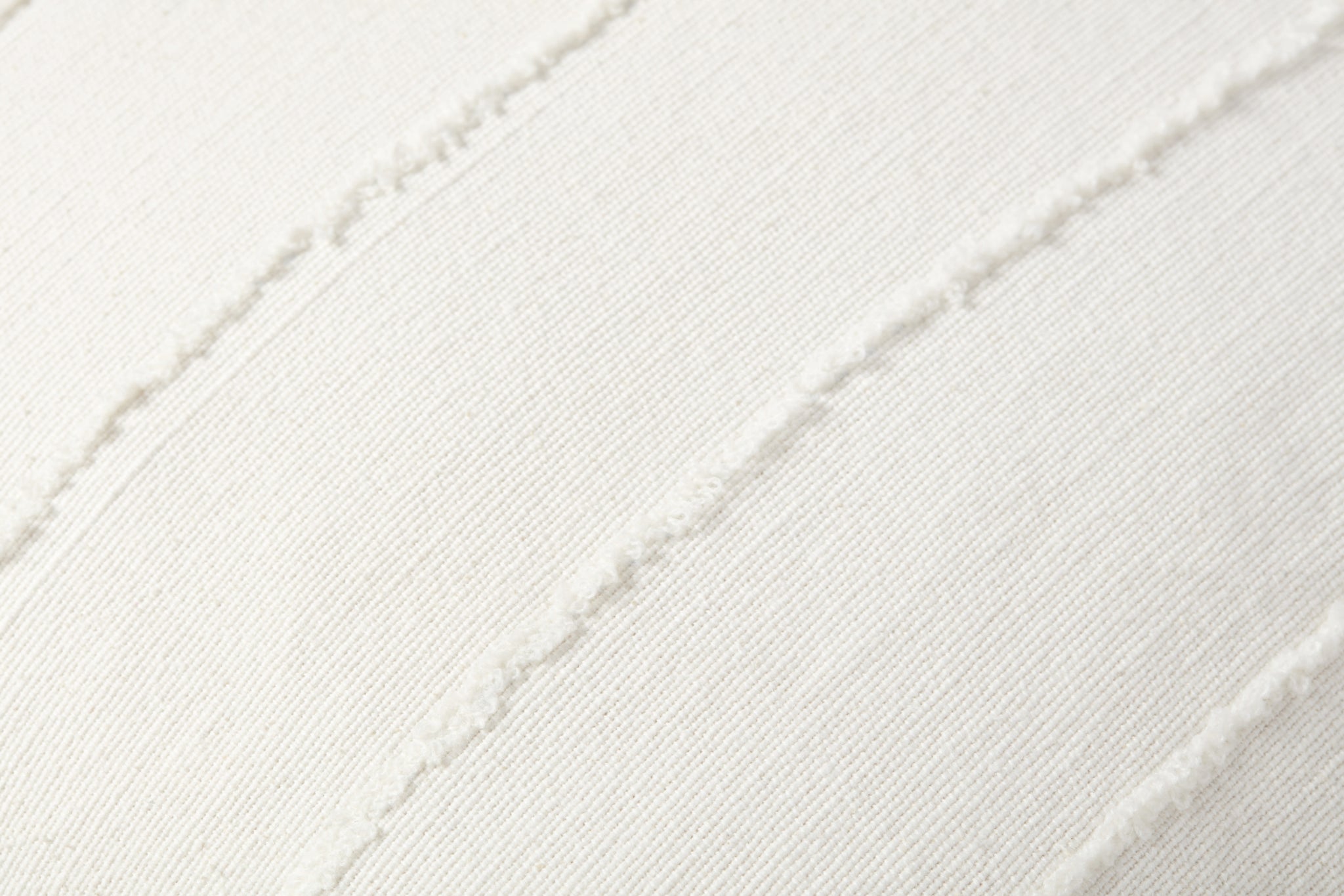Julia Ivory Pillow shown from a different angle to reveal its pattern.