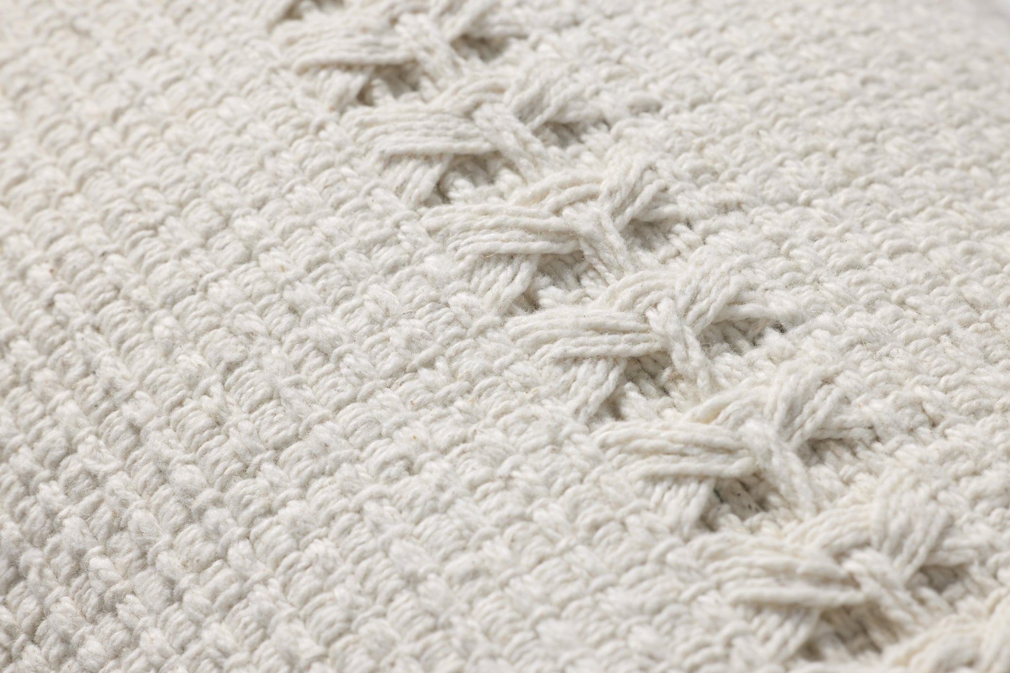 Harvey White Pillow shown from a different angle to reveal its pattern.