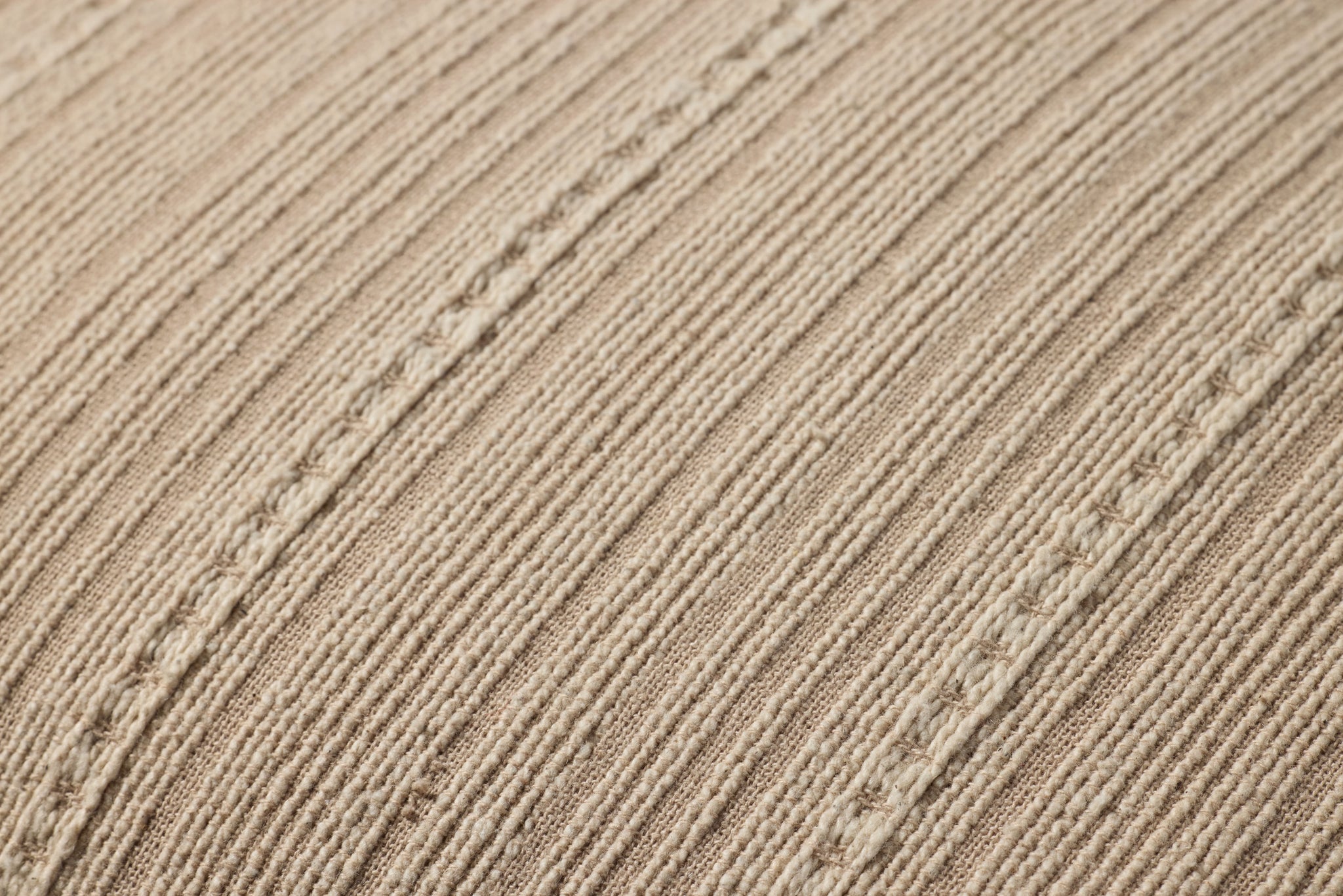 Howie Natural Pillow shown from a different angle to reveal its pattern.