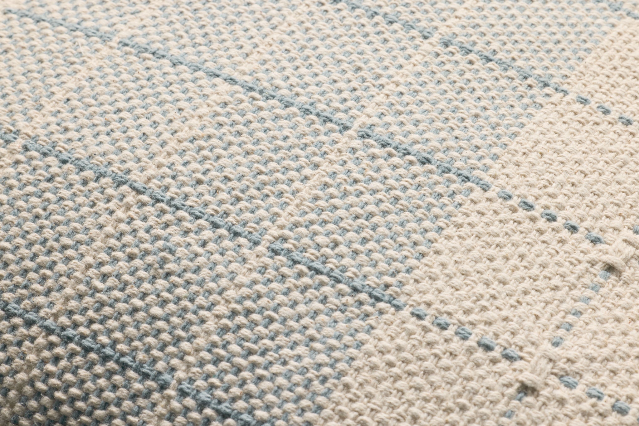 Blue / Natural Pillow shown from a different angle to reveal its pattern.