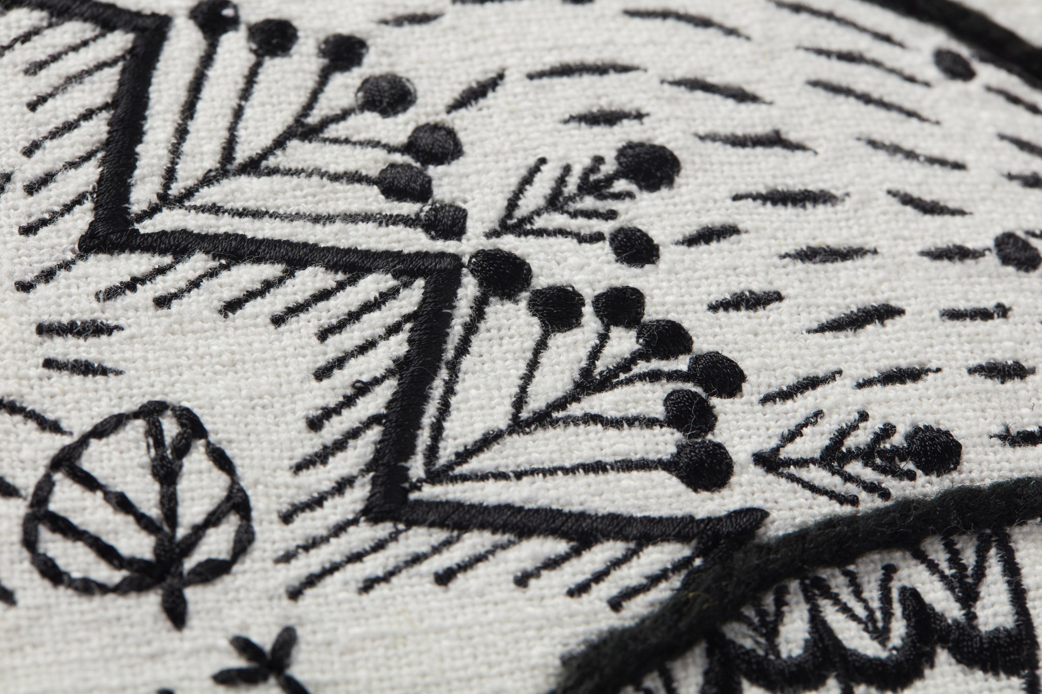 Black / Natural Pillow shown from a different angle to reveal its pattern.