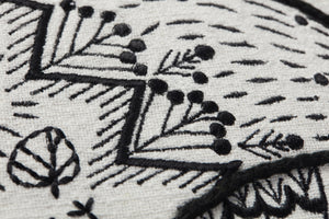 Black / Natural Pillow shown from a different angle to reveal its pattern.