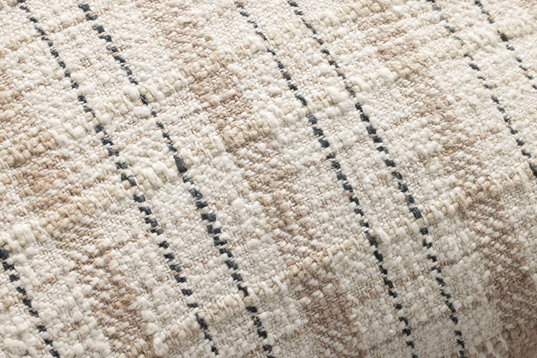 Cricket Beige / Black Pillow shown from a different angle to reveal its pattern.
