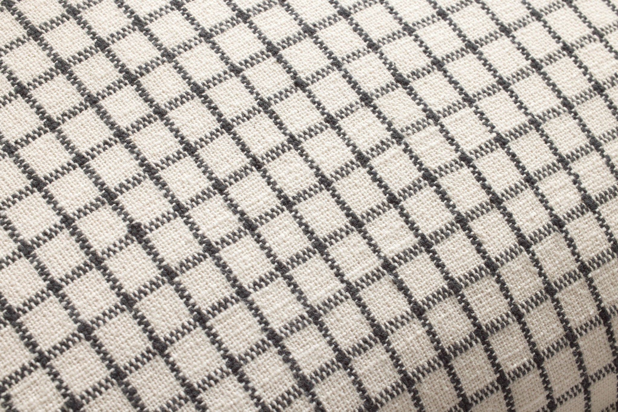 Dinah Ivory / Black Pillow shown from a different angle to reveal its pattern.