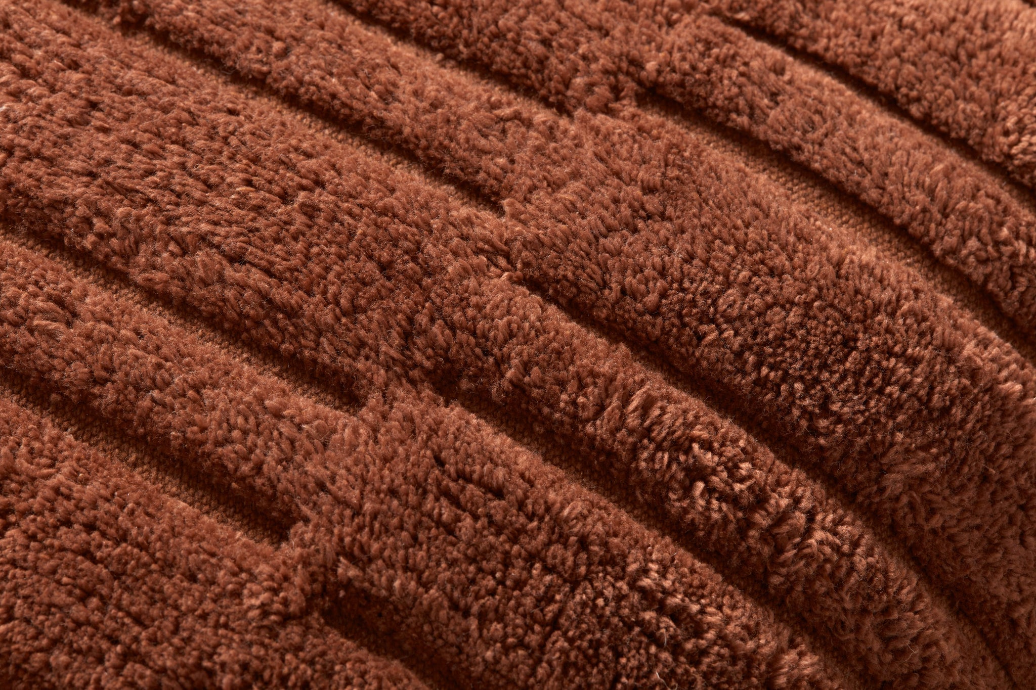 Arabella Rust Pillow shown from a different angle to reveal its pattern.