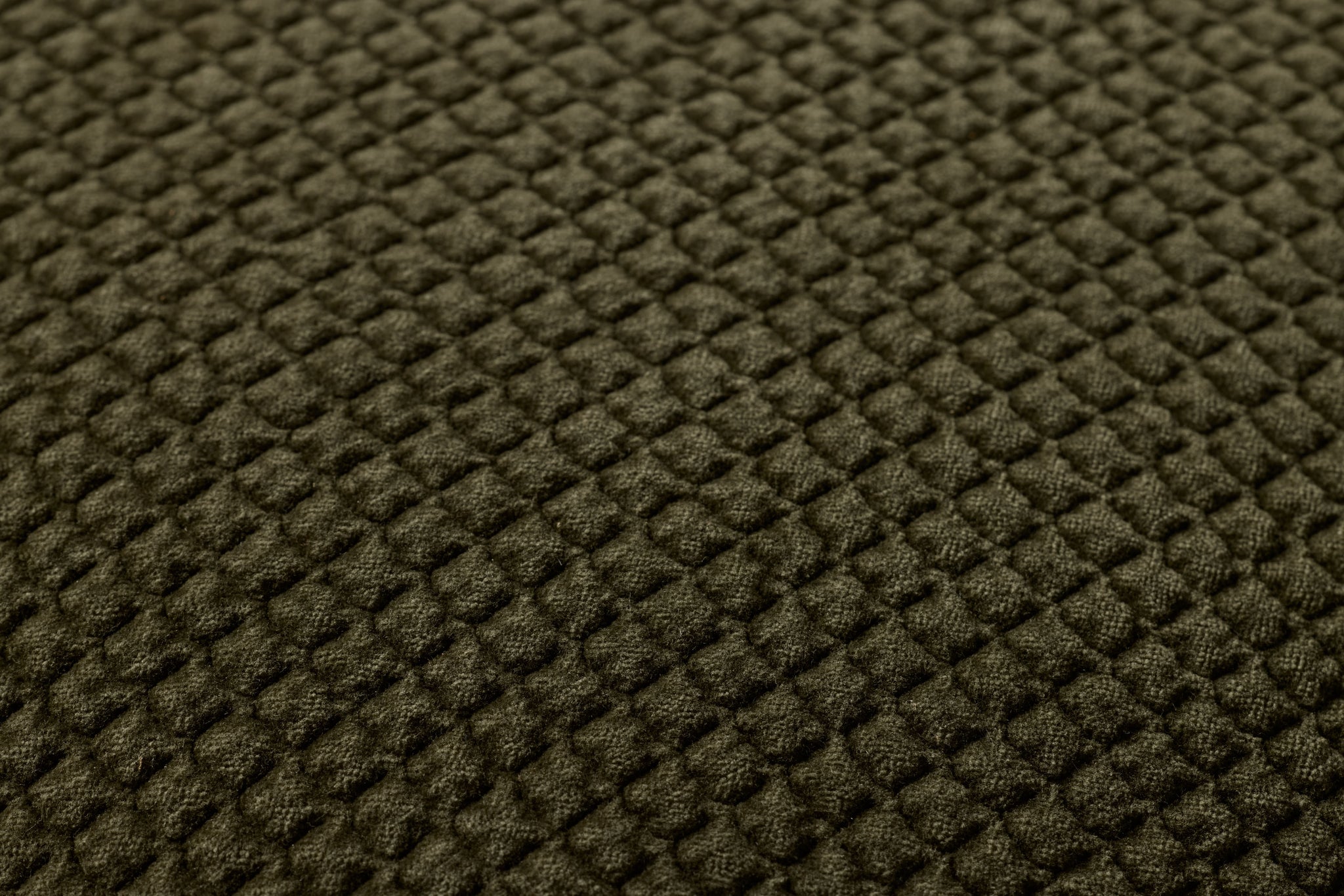 Dark Olive Pillow shown from a different angle to reveal its pattern.