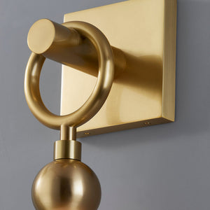 Perrin Wall Sconce in aged brass shown from the front to reveal the arm curve and shade silhouette.
