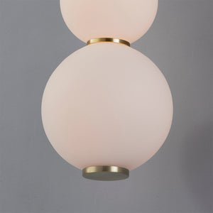 Close-up of the Perrin Wall Sconce in aged brass showing the arm curve and shade silhouette.