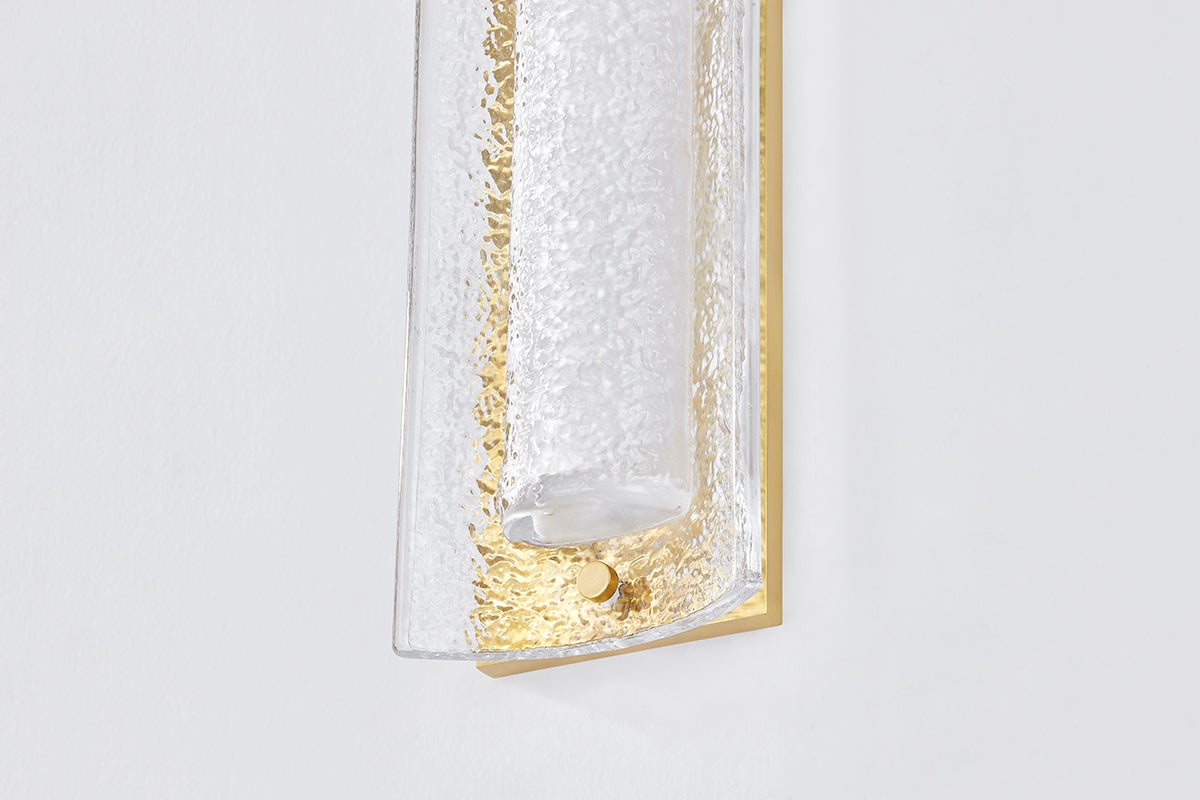 Philmont Wall Sconce in aged brass shown from the front to reveal the arm curve and shade silhouette.