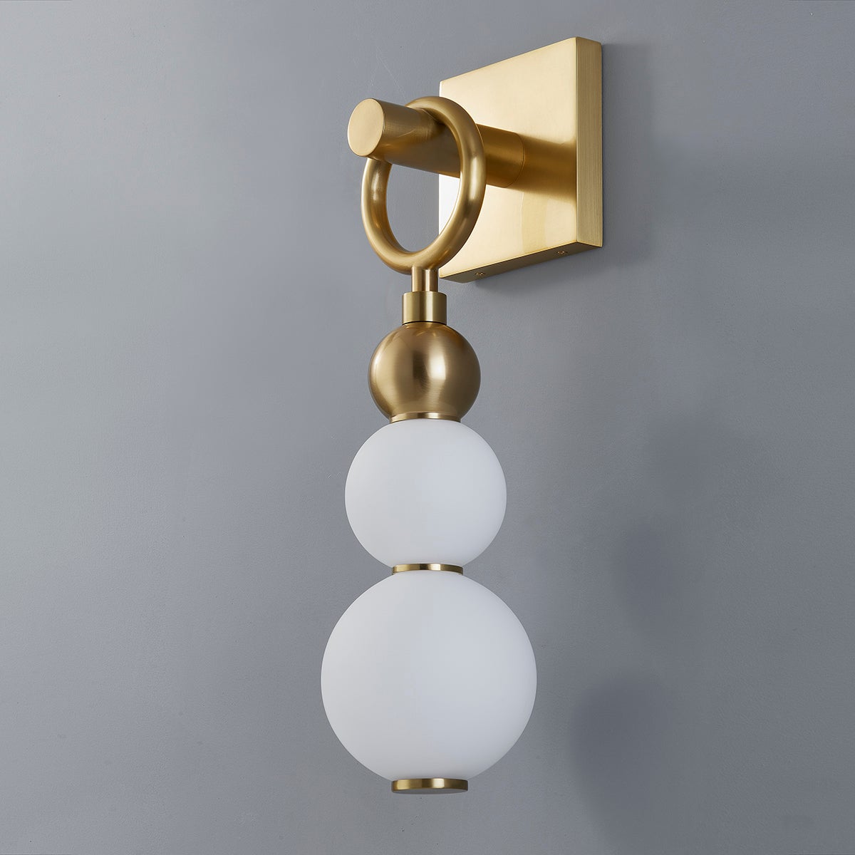 Close-up of the Perrin Wall Sconce in aged brass showing the arm curve and shade silhouette.