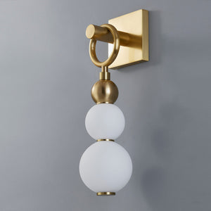 Close-up of the Perrin Wall Sconce in aged brass showing the arm curve and shade silhouette.