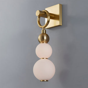 Close-up of the Perrin Wall Sconce in aged brass showing the arm curve and shade silhouette.