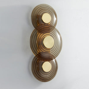 Close-up of the Griston Wall Sconce 12" x 25.75" in aged brass showing the arm curve and shade silhouette.