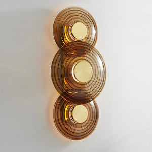 Close-up of the Griston Wall Sconce 12" x 25.75" in aged brass showing the arm curve and shade silhouette.