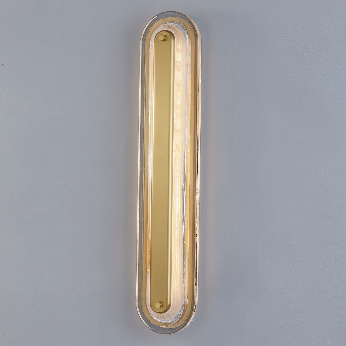 Close-up of the Litton Wall Sconce 5.75" x 28" in aged brass showing the arm curve and shade silhouette.