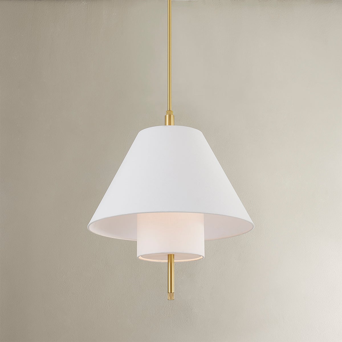 Close-up of the Glenmoore Pendant in aged brass showing the shade shape and metal detail.