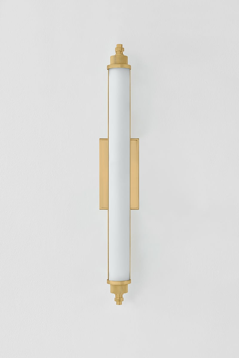 Plandome Bath And Vanity 4.25" x 28" in aged brass shown from the front to reveal the arm spread and shade silhouette.
