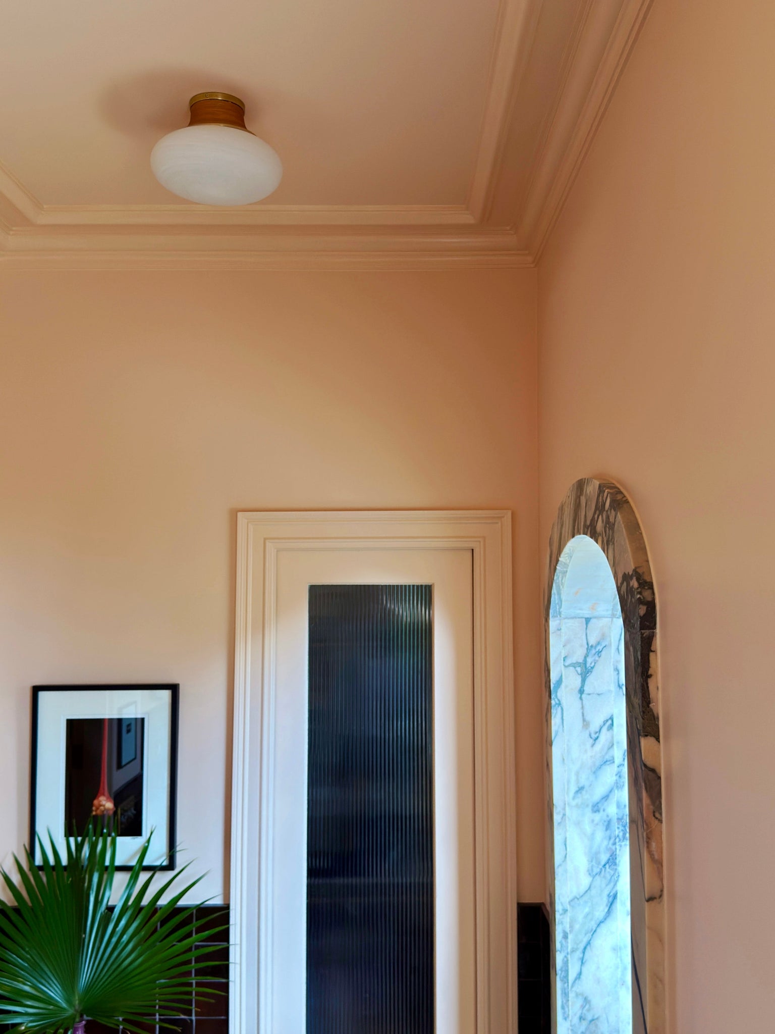 Pearl River Flush Mount 11" in aged brass styled in a bedroom for warm, layered light at Laurie Yapp Home.