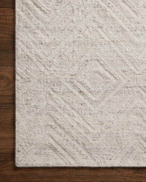 Side view of the Raven Ivory / Pebble rug.
