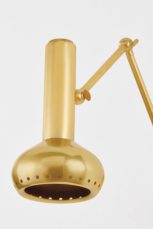 Close-up of the Roald Wall Sconce in aged brass showing the arm curve and shade silhouette.
