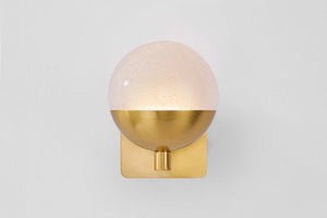 Rochford Wall Sconce in aged brass shown from the front to reveal the arm curve and shade silhouette.