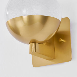 Close-up of the Rochford Wall Sconce in aged brass showing the arm curve and shade silhouette.