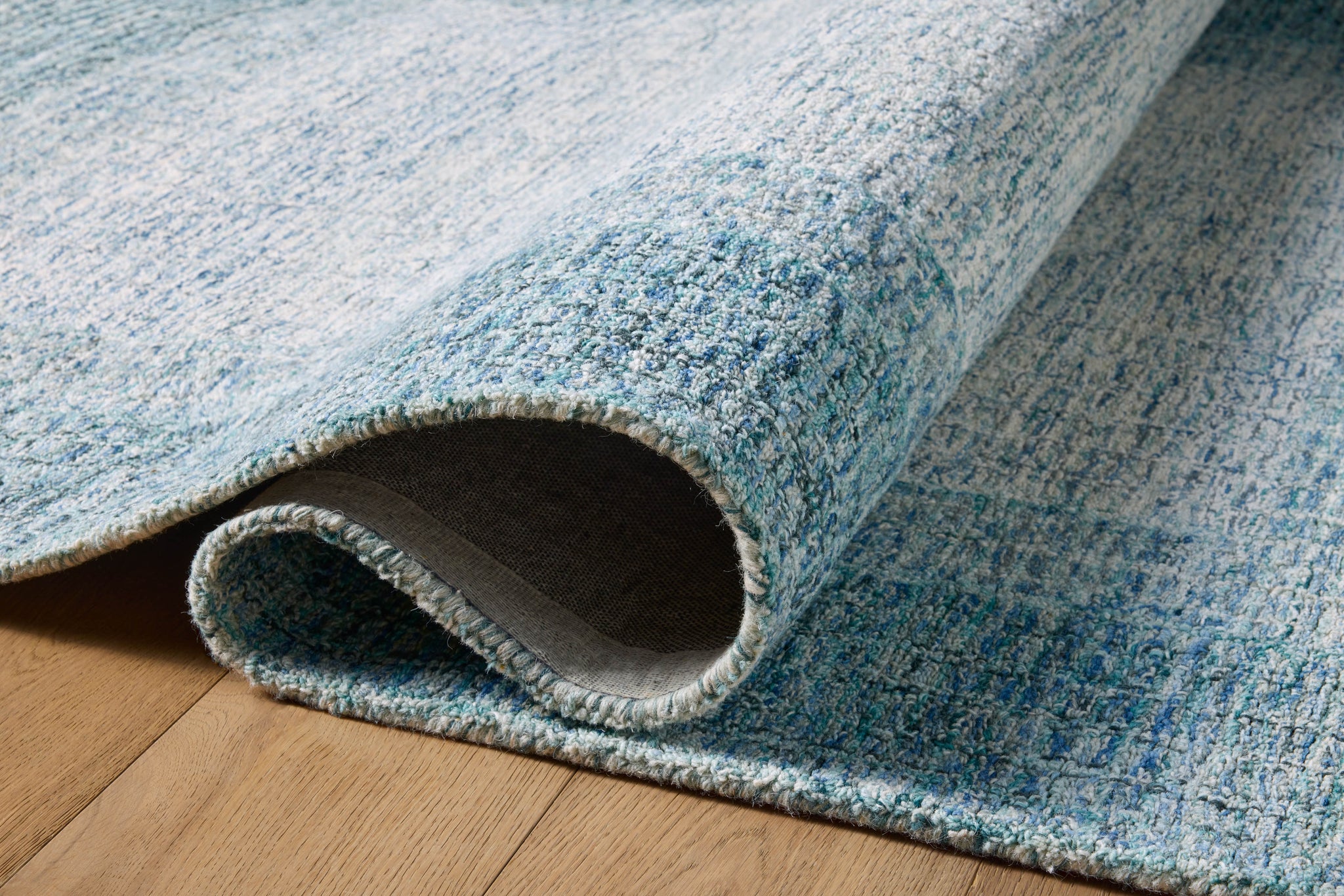 Rosina Aqua styled underfoot in a layered living room at Laurie Yapp Home.