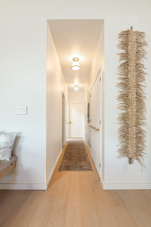 Randolph Semi Flush in aged brass styled in a bedroom for warm, layered light at Laurie Yapp Home.