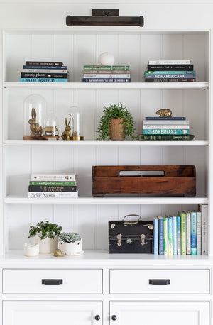 Ridgewood Picture Light 16.5" in dark bronze styled in a reading room for warm, layered light at Laurie Yapp Home.