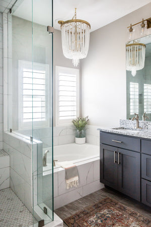 Royalton Chandelier 18.25" in aged brass styled in an elegant dining room for warm, layered light at Laurie Yapp Home.