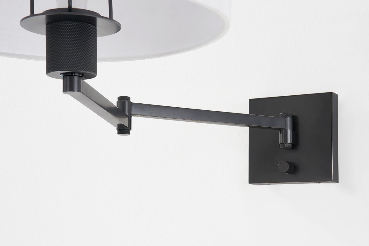 Close-up of the Sammy Wall Sconce in bronze showing the arm curve and shade silhouette.