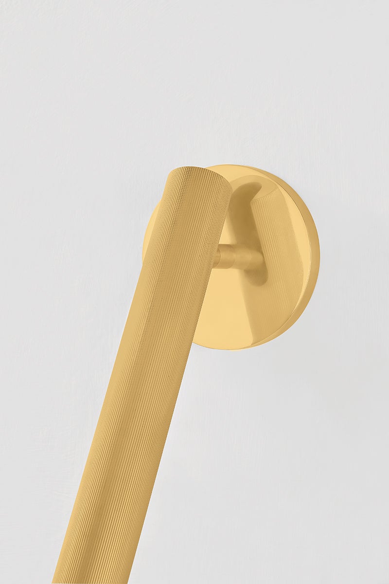 Close-up of the Simeon Wall Sconce in aged brass showing the arm curve and shade silhouette.