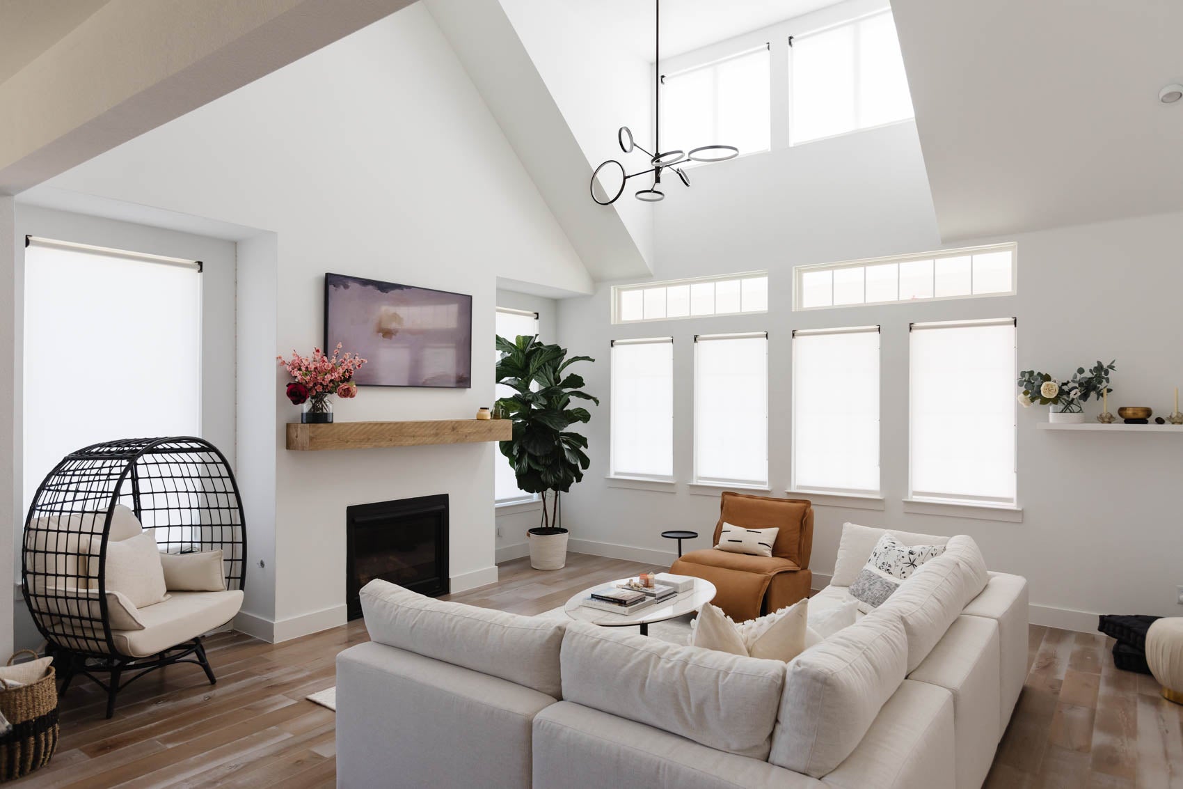 Saturn Chandelier in Aged Brass styled in a formal living room for warm, layered light at Laurie Yapp Home.